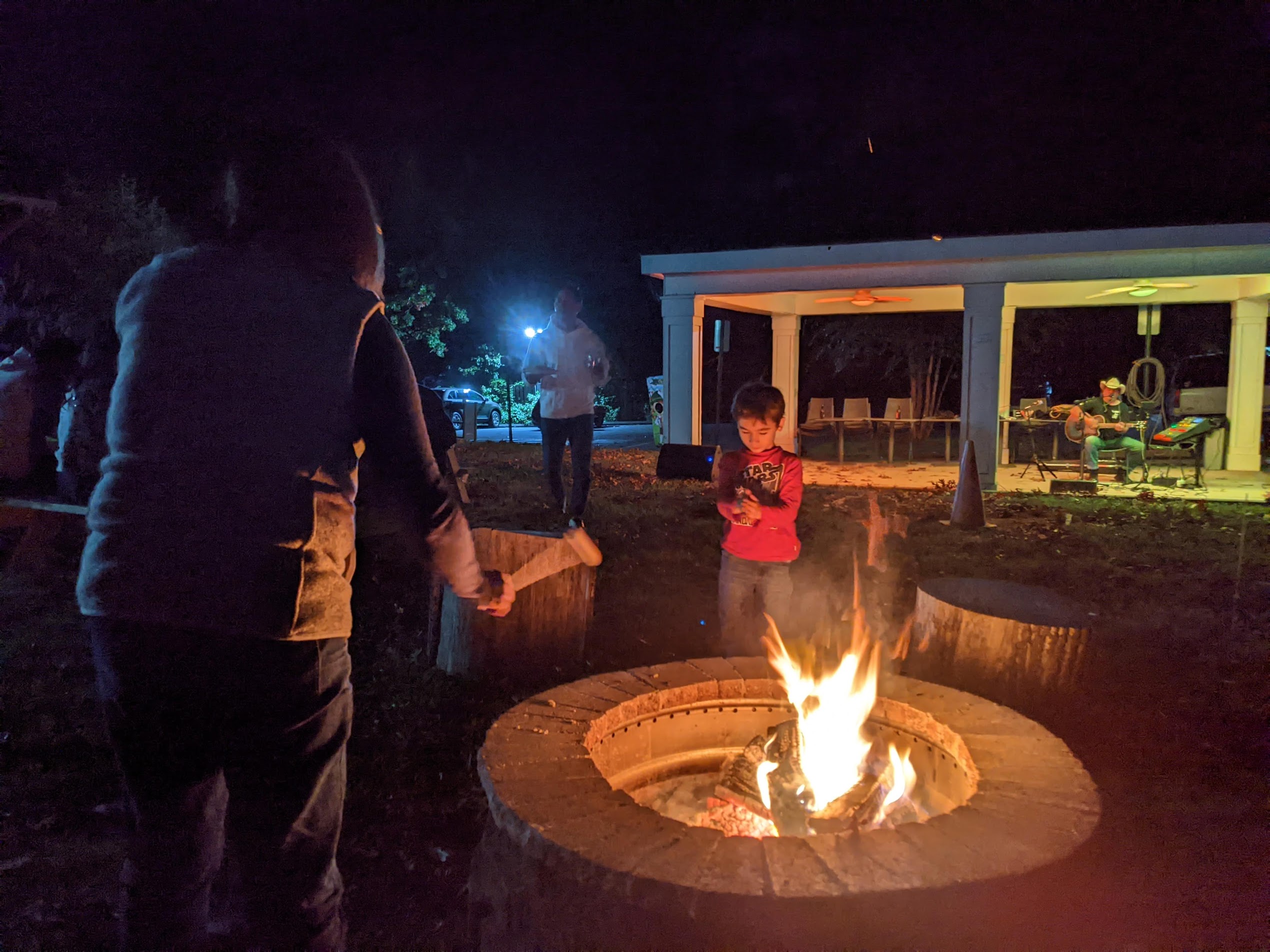 Members gathering around the outdoor firepit